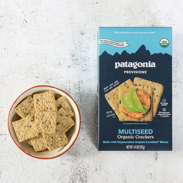 Patagonia Provisions Multiseed Organic Crackers packaging with a bowl of crackers on a textured surface