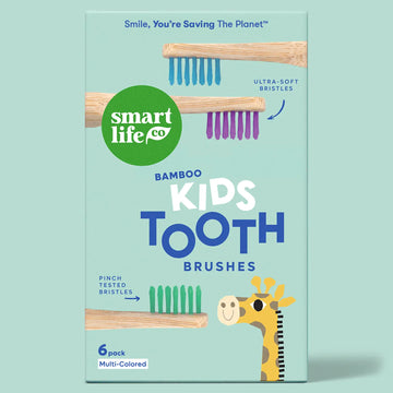 Packaging of smart life co bamboo kids toothbrushes with a cartoon giraffe on a light blue background.