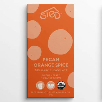 Orange chocolate bar packaging with 'Sted' branding and pecan orange spice flavor details.