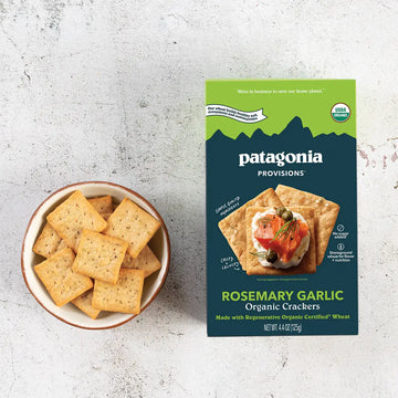 Patagonia Provisions Rosemary Garlic Organic Crackers packaging with a bowl of crackers on a light gray background