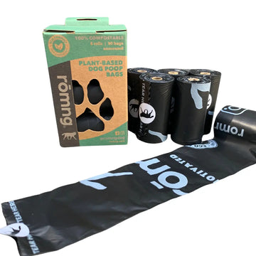 Rolls of plant-based dog poop bags with packaging on a white background