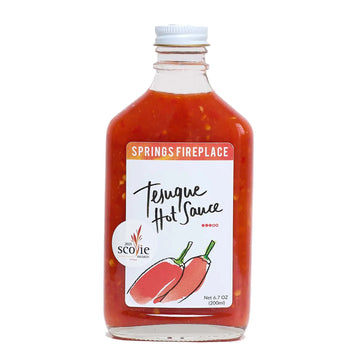 Bottle of Springs Fireplace Tejque Hot Sauce on a white background