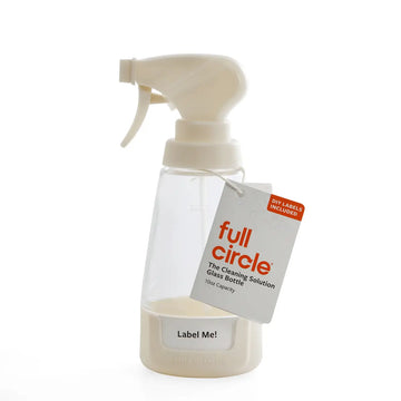 Clear glass spray bottle with white spray nozzle and 'full circle' label on a white background