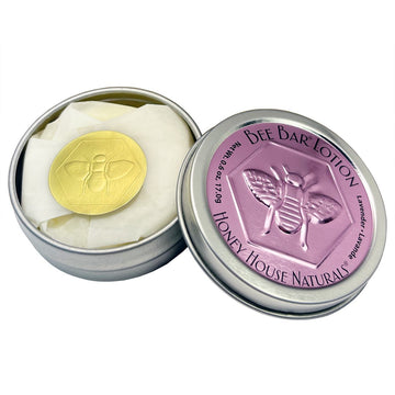 Bee bar lotion in a metal tin with 'Honey House Naturals' branding on a white background