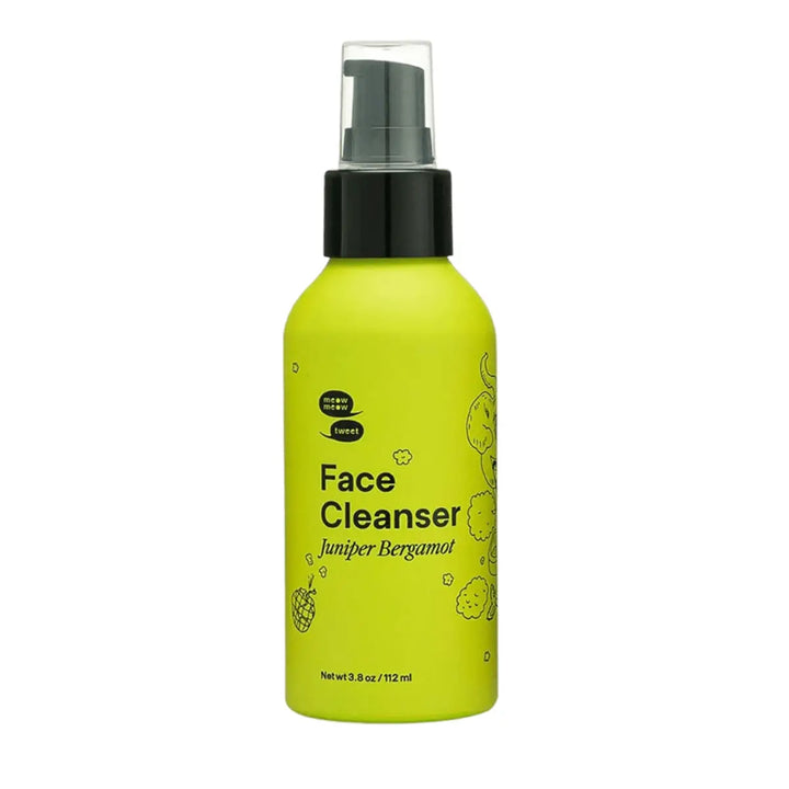 Green bottle of face cleanser with black spray nozzle on a white background