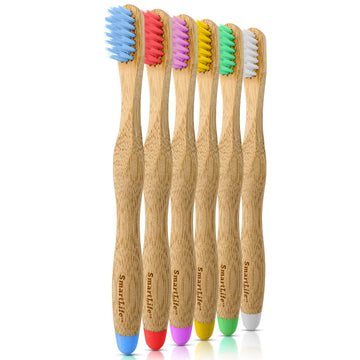 Set of five bamboo toothbrushes with colored bristles and handles on a white background