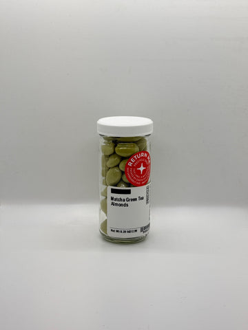 Jar of matcha green tea almonds on a gray background
