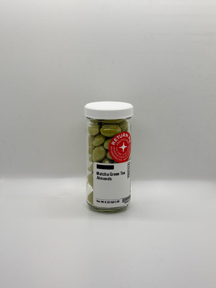 Jar of matcha green tea almonds on a gray background