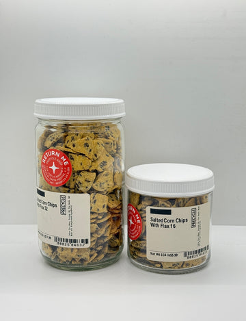 Two jars of salted corn chips with flax seeds on a white background
