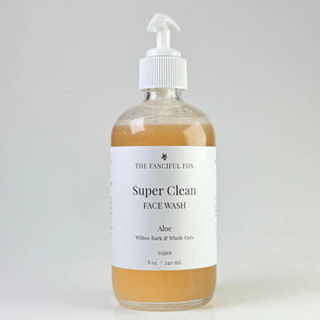 Bottle of 'Super Clean' face wash with a label on a white background